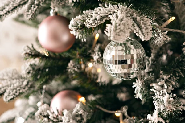 Christmas decorations on the branches of a Christmas tree with snow — Stock Photo, Image