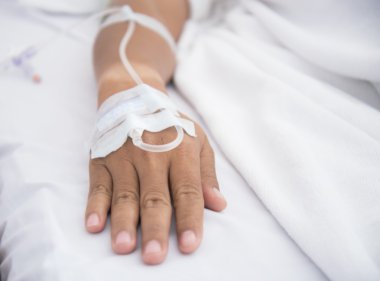 Close up of a patient in hospital with saline intravenous (iv), select focus clipart