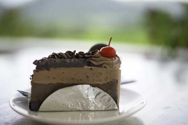 Delicious chocolate cake on plate on table — Stock Photo, Image