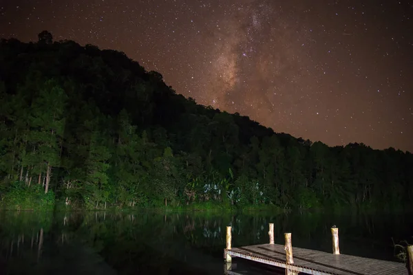 Samanyolu peyzaj rezervuar dağ ve gece gökyüzüne derin orman üzerinde.