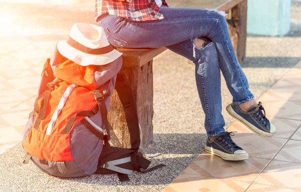 Traveler women wearing backpack  waiting for a train.