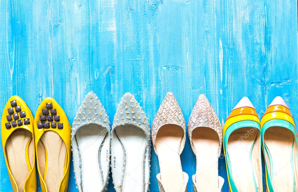 Collection of women's shoes on blue background