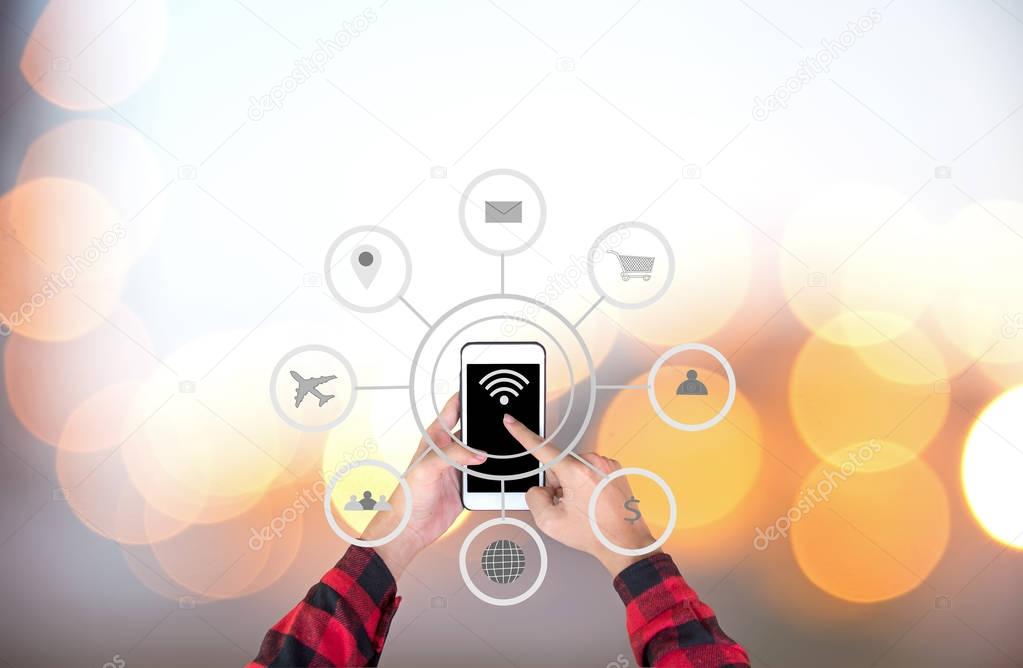 Businessman touching smart phone automation concept with icons showing the functionalities of this new technology