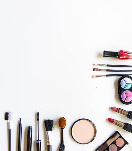 Cosmetics and fashion background with make up artist objects: lipstick, eye shadows, mascara ,eyeliner, concealer, nail polish.  Lifestyle Concept
