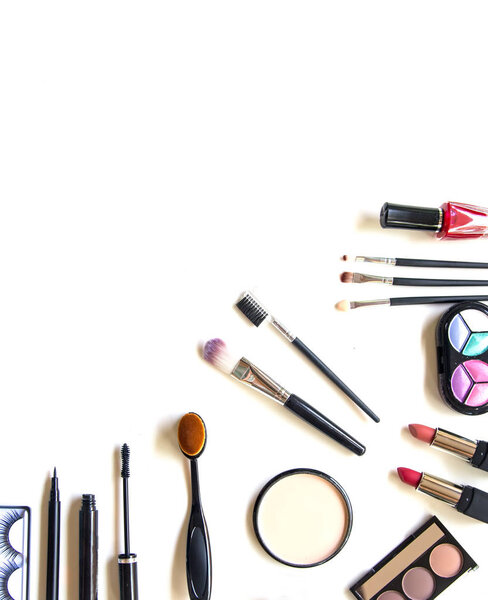 Cosmetics and fashion background with make up artist objects: lipstick, eye shadows, mascara ,eyeliner, concealer, nail polish.  Lifestyle Concep