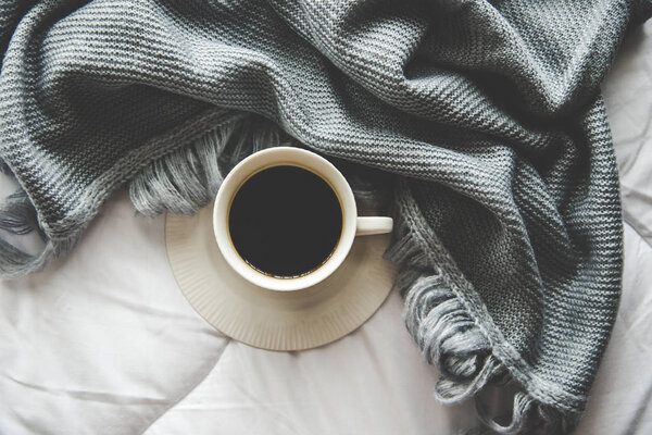 Cozy winter home background, cup of hot coffee with marshmallow, warm knitted sweater on white bed background, vintage tone.  Lifestyle concept — Stock Photo, Image