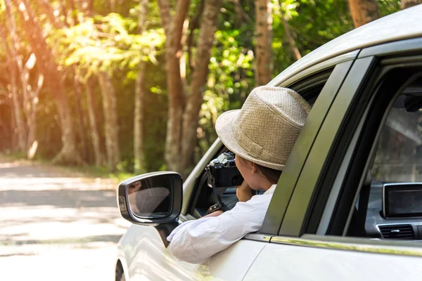 Asain woman traveler take a photo with hatchback car to trave on the road forest.  Travel Concept — Stock Photo, Image
