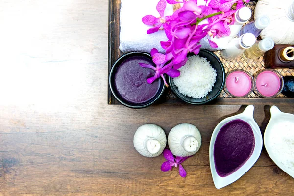 Thai Spa Treatments aroma therapy  salt and sugar scrub and rock massage with orchid flower on wooden.  Healthy Concept. copy space,select and soft focus