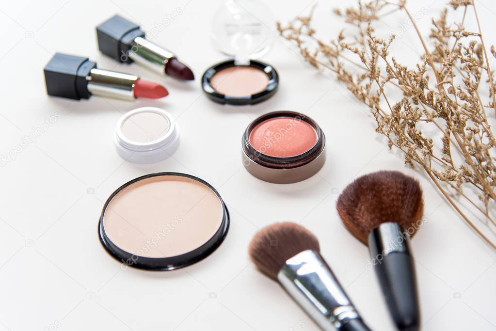 Makeup cosmetics tools background and beauty cosmetics, products and facial cosmetics package lipstick, eyeshadow on the white background
