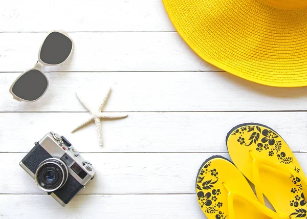 Verão moda mulher amarelo grande chapéu e acessórios na praia. Mar tropical. Vista superior incomum, fundo branco de madeira. Conceito de Verão . — Fotografia de Stock