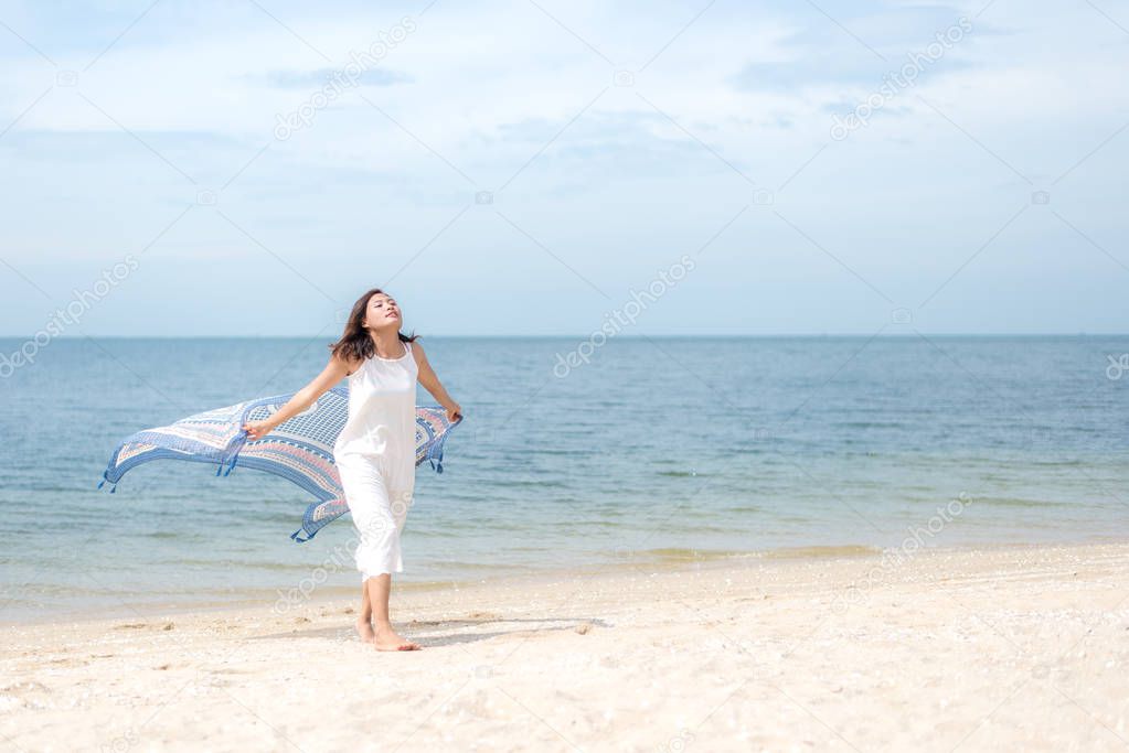 Freedom aisan young women jumping and happy on the suumer beach. Travel and Vacation. Freedom & Lifestyle Concept
