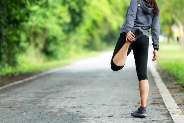 Healthy Smiling Woman Warming Stretching Her Legs Looking Away Road — Stock Photo, Image