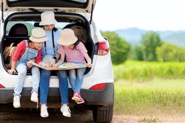 Group family children travel on car for adventure nature in vacations.  Asia people tourism checking map for explore natural destination and leisure trips travel for education.  Travel Concept