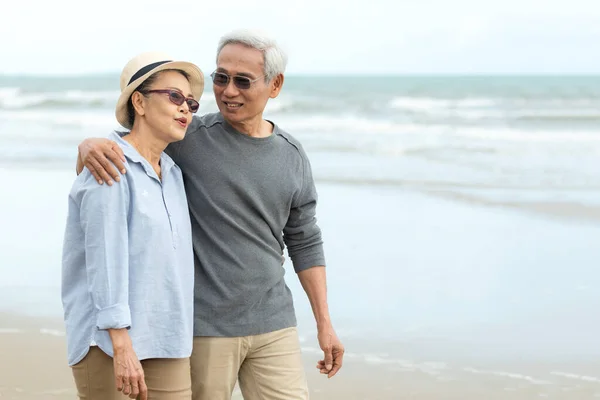 Lifestyle asian people senior couple walking happy and relax on the beach. Tourism elderly family travel leisure and activity after retirement vacations and summer.
