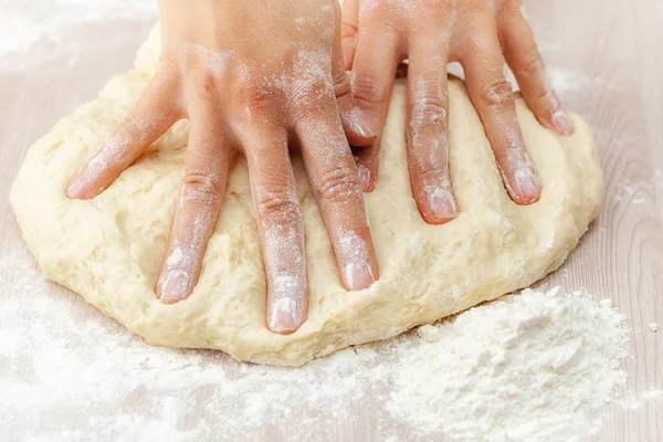 Dough for festive baking in the skillful hands of the hostess close-up, Russia — Stock Photo, Image