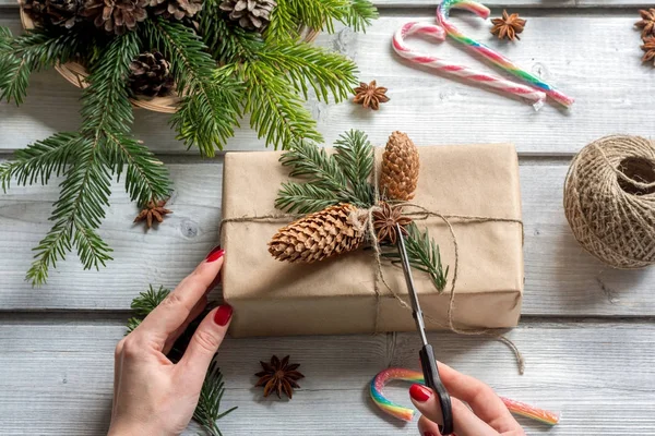 Woman hands decorating gift box in Christmas style. View from above — Stock Photo, Image