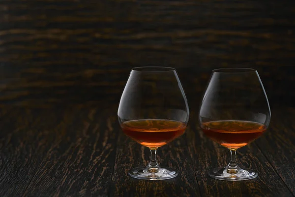 Cognac on a wooden table, selective focus with copy space. — 스톡 사진