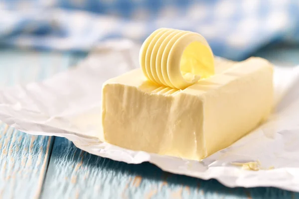 Piece Butter Blue Wooden Table Selective Focus — Stock Photo, Image