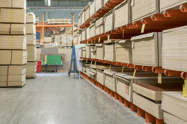 Fiberboard and chipboard sheets on shelves in the building materials store. — Stock Image Fiberboard and chipboard sheets on shelves in the building materials store. Stock Image