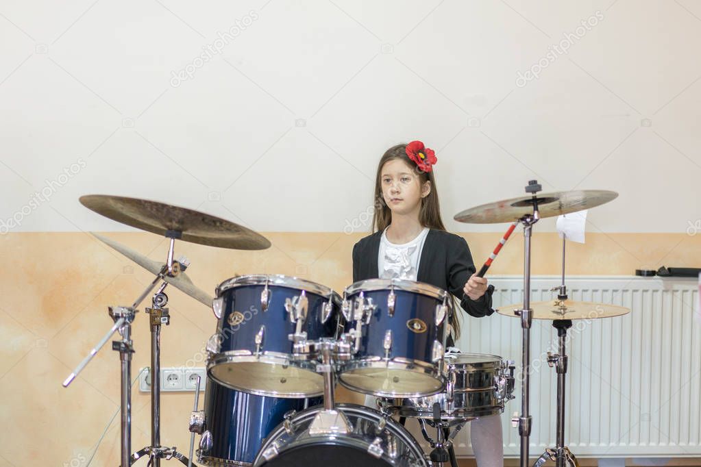 girl playing the drum set.