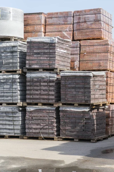 pallets with bricks in the building store. Racks with brick. Masonry, stonework.