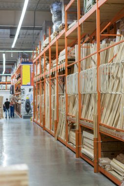 interior of hardware retailer with aisles, shelves, racks of building material insulation floor to ceiling clipart
