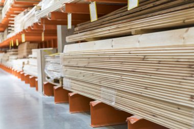 Boards on rack in construction store. Construction and repair concept.