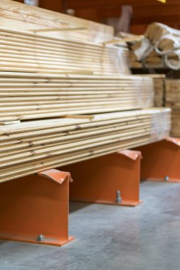 Boards on rack in construction store. Construction and repair concept.