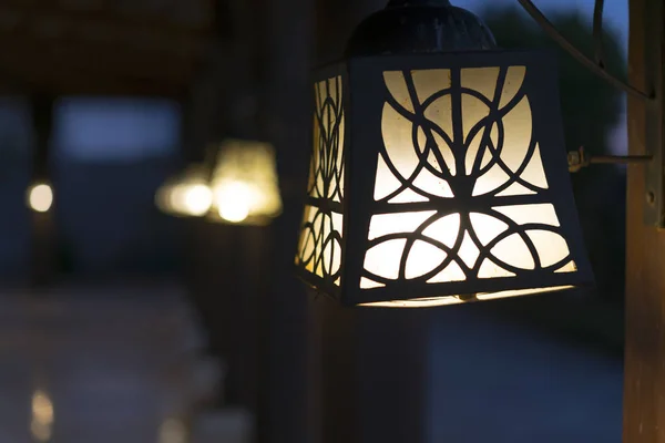 Street lamps on wooden poles. Street lighting.