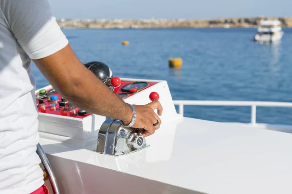 Captain at the helm yacht. Man driving yacht. Concept of sea recreation and tourism.