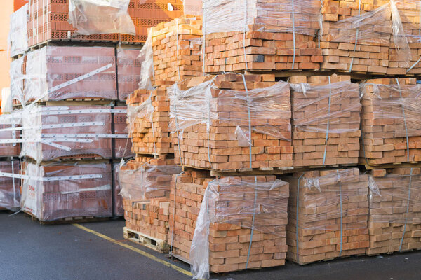 Clay bricks stored for building construction. Industrial production of bricks.