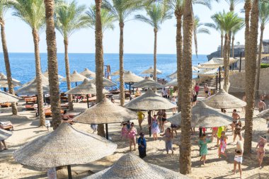Sharm El Sheikh, Egypt - November 21, 2019: Tourists and animators dancing on the beach. 