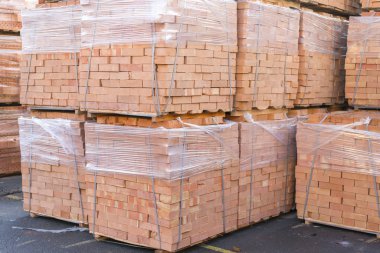 Clay bricks stored for building construction. Industrial production of bricks.