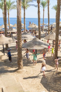 Sharm El Sheikh, Egypt - November 21, 2019: Tourists and animators dancing on the beach. Animators entertaining visitors at the music. 