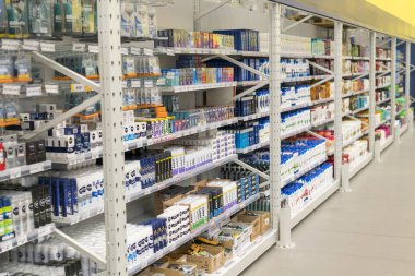 Kiev, Ukraine - July 19, 2019: Condoms and Shavers, foam and shaving gel on shelf in store.