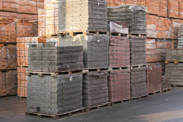 Pallets with bricks in the building store.