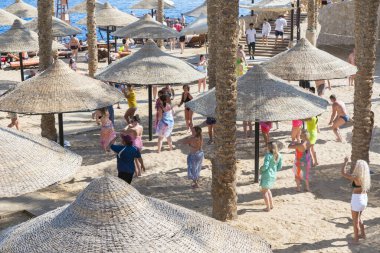Sharm El Sheikh, Egypt - November 21, 2019: Tourists and animators dancing on the beach. 