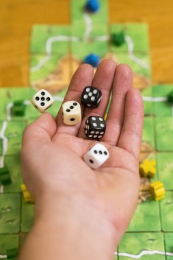 Rengarenk bulanık fantezi masa oyunlarının arka planına el yordamıyla zar atmak, dinamikteki oyun anları. Seçili odak.