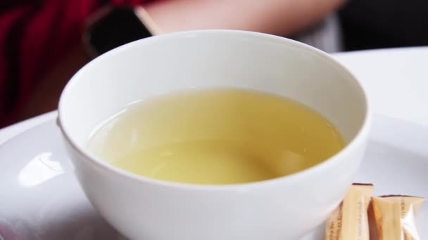 Girl stir tea. teaspoon. A cup of tea. Close up — Stock Video