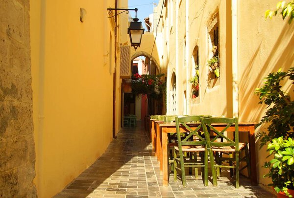 Morning dream of tables and chairs on a quiet street in Rethymno, Greece