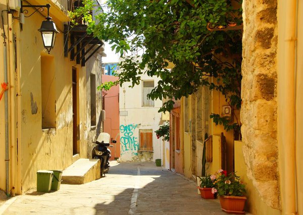 Sunny morning on the narrow street of the old city in Rethymnon, Greece