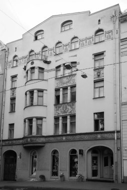 Riga 'nın merkez caddelerinden birinde ulusal romantizm tarzında bir konut kapısı olan ön cephenin bir parçası.