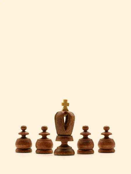 Leadership Concept: Black King Chess Piece With Four Pawns