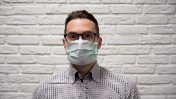 매력적 사업가인 남자가 체크무늬 셔츠를 보호용 의료용 마스크를 머리를 위아래로 — 비디오