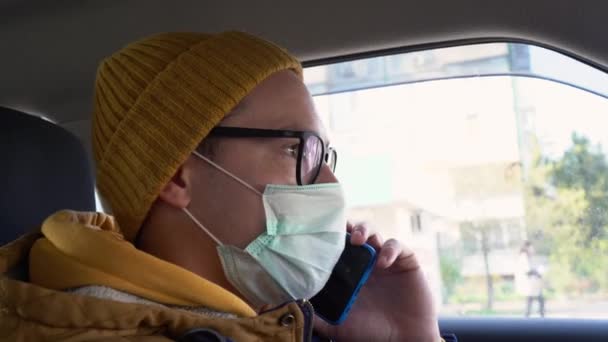 Egy Férfi Télen Sárga Sapkában Meleg Kék Kabátban Orvosi Védőmaszkban — Stock videók