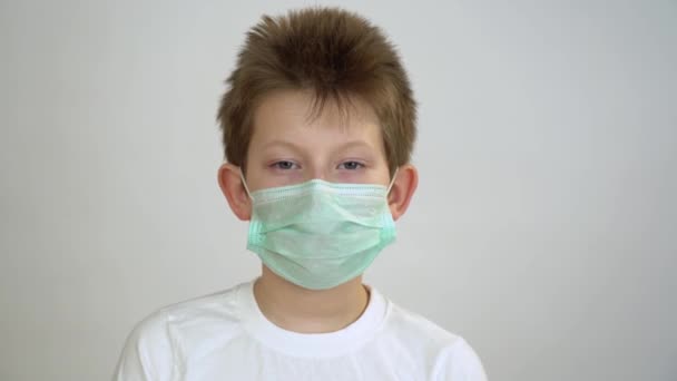 Caucasian Attractive Blonde Kid White Shirt Takes Protective Medical Face — Stock Video