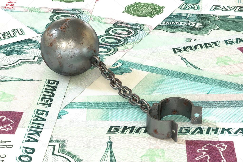 Rusty iron ball and chain connected to open cuff lying on rouble banknotes background