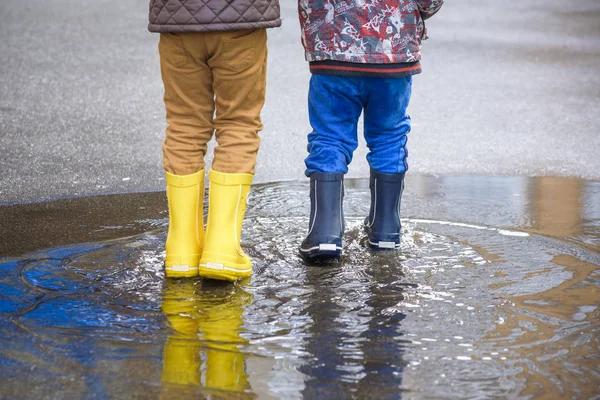 happy kids jumping under the rain