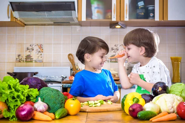 Healthy eating. Happy children prepares and eats vegetable salad