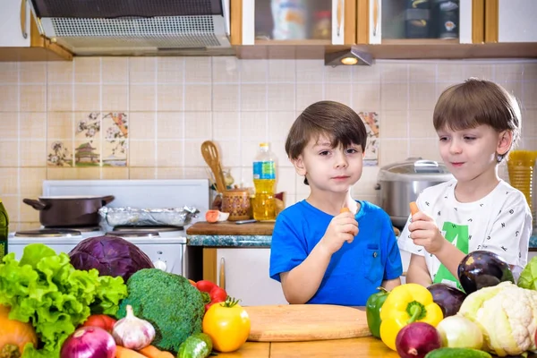 Healthy eating. Happy children prepares and eats vegetable salad